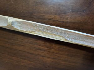 Bamboo Shinai slat with a chipped edge on its side